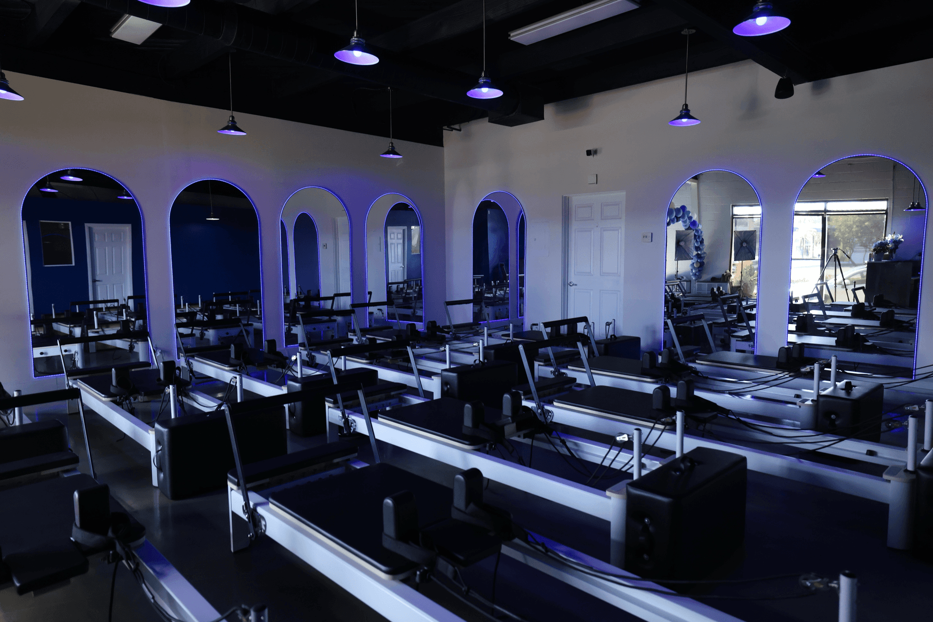 Interior of Void Pilates studio with reformer machines in dramatic lighting